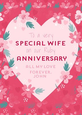 Heart Shaped Frame Surrounded By Flowers On A Pink Background Anniversary Card 