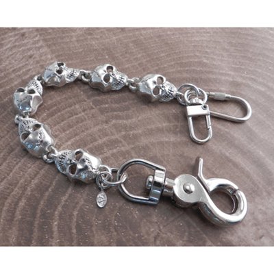 Silver; Pewter chain with antique sterling silver plating; with massive 1" long skulls; the sturdy snap hook and dual wallet hook end-pieces adds approximately 3" to the chain length