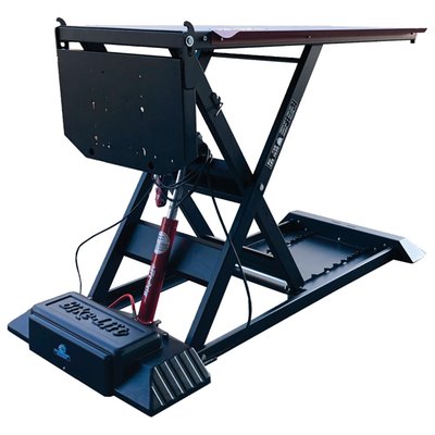 Black powder coated. Max load: 750kg; Lift weight: 265kg; Min height: 20cm; Max height: 130cm; Table top: 220cm long x 75cm wide; Table top with side wings: 220 long x 92cm wide; Side wings: 161cm long x 8.5cm wide; Rear slide-away drop gate panel: 60cm long x 36cm wide; Front fold-down pivoting split section: 44.5cm long x 75cm wide; Overall dimensions: 230cm x 92cm; Run-up ramp: 82 x 51cm.
Professional scissor style motorcycle lift for workshops. Comes with a 230V electric operated hydraulic pump with a wired remote control for easy & dependable control with built-in magnet for easy storage on the lift. The front fold-down pivoting split section of 44.5cm long x 75cm wide gives front wheel access and a slide-away rear drop gate panel of 60cm long x 36cm wide allows easy access to the rear wheel. Full table top length is 220cm long x 75cm wide without side wings. The side wings are 161cm long x 8.5cm wide and run on both sides over its full non-pivoting length for easy momentary storage of nuts, bolts and other small parts. The lift comes with safety locking positions in 8 different heights and a removable front safety bar to prevent over-shooting the lift when rolling on the bike.