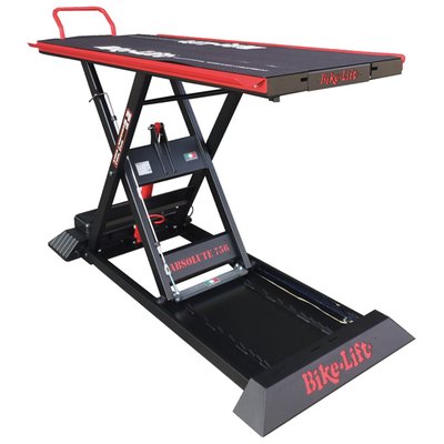 Black powder coated. Max load: 750kg; Lift weight: 260kg; Min height: 20cm; Max height: 130cm; Table top: 220cm long x 75cm wide; Table top with side wings: 220 long x 92cm wide; Side wings: 212cm long x 8.5cm wide; Rear slide-away drop gate panel: 60cm long x 36cm wide; Overall dimensions: 230cm x 92cm; Run-up ramp: 82 x 51cm.
Professional scissor style motorcycle lift for workshops. Comes with a 230V electric operated hydraulic pump with a wired remote control for easy & dependable control with built-in magnet for easy storage on the lift. A slide-away rear drop gate panel of 60cm long x 36cm wide allows easy access to the rear wheel. Full table top length is 220cm long x 75cm wide without side wings. The side wings are 212cm long x 8.5cm wide and run on both sides over its full length for easy momentary storage of nuts, bolts and other small parts. The lift comes with safety locking positions in 8 different heights and a removable front safety bar to prevent over-shooting the lift when rolling on the bike.