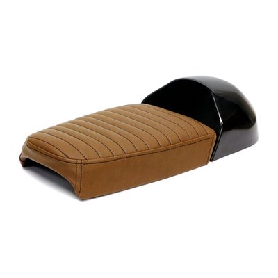 Dark brown synthetic leather upholstery. A Jekyll & Hyde seat that converts from a solo to a fully functional two-up seat in seconds, without breaking a sweat. Great for an occasional passenger, at any moment. Consists of 4 parts, a seat base, seat cowl, 2x the upholstery base with 6 mounting points (M6-Steel plus nuts) to allow easy installation. Made from unpainted black ABS plastic and comes with 40mm thick seat foam that is covered with a water repellent membrane below the synthetic leather upholstery. 
Note: Installation modifications may be required.