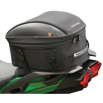 The Commuter Touring tail bag is perfect for larger seats, roomy enough for a few days’ worth of clothes and expands to easily carry a full face helmet. Upgrades for these bags include a quick release mounting system which can also just attach around the seat for a clean look, EVA molded lid with carbon-like accents, internal self-fastening straps to better secure your contents and they are all made using UltraMax® material for a high level of UV protection. Other features still include a flush mount reflective carry handle, mesh pocket under the lid, easy slide lockable zippers, anti-slip base material and a waterproof rain cover.
- UltraMax® fabric with UV protection.
- Expands to hold a full-face helmet.
- Easily mounts to most tail sections and seats.
- Mounts with 4 quick release straps.
- Molded EVA lid with Fibertech "carbon-like" accents.
- Bag maintains shape, has reflective piping and a lined interior.
- Lockable reverse coil zippers and hi-density rubber zipper pullers.
- Inside self-fastening straps to better secure contents.
- Flush mount reflective handle and mesh.
- 100% waterproof rain cover and adjustable shoulder/backpack strap.
- Main compartment measures: 14"L x 12"W x 9"H Standard / 14"L x 12"W x 12"H expanded.
- Holds 24.78 Liters / 33.04 Liters expanded.
- Fully expandable with a protective base material.