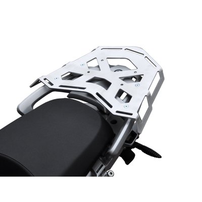 This silver powdercoated luggage rack is made from 4mm thick and laser cut aluminum. It can be mounted to the original support plate to enlarge the rack's surface area. The slots for the fastening straps secure the luggage directly on the luggage rack. 