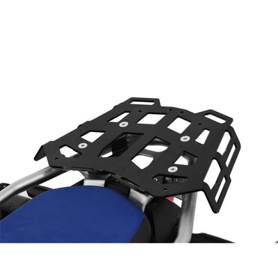 This black powdercoated luggage rack is made from 4mm thick and laser cut aluminum. It can be mounted to the original support plate to enlarge the rack's surface area. The slots for the fastening straps secure the luggage directly on the luggage rack. 