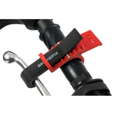 Front brake lever clamping device. Effectively allows you to use the front brake as a parking brake. As a help during transport, or parking in mountains. Quickly installs and uninstalls on virtually all brake lever / throttle combinations due to the different position clip-closure adjustability.