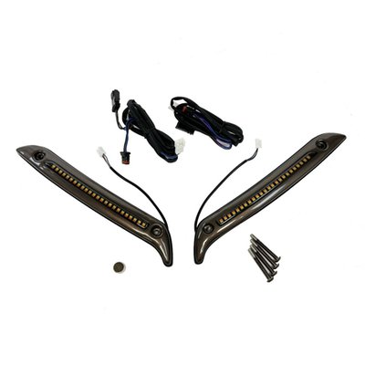 This windshield DRL/turn signal trim is installed to the lower side of the windshield, to the fairing body. Comes as a low profile metal housing, which hold a single row of dual color LEDs behind a smoked lens. 
Offers bright white DRL and full contrast, customizable amber turn signals. Select one of three built-in turn signal modes by using the provided magnet. Turn signals can be set to flash solid on, sequential on (LEDs turn on from center of the bike, outwards) or sequential off (all LEDs on, then turn off from center of the bike, outwards). Extended wire leads plug in under the fairing for easy installation.