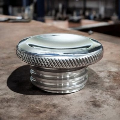 Clear polished billet aluminum. 
Right hand threaded. Vented. Aluminum gas cap that can be used as a vented or non-vented fuel cap, since it can be assembled with the vents open or closed. It comes assembled with vents open for H-D use. The dished top gives it that custom look, the knurling takes care of sufficient grip to open the fuel cap. 
