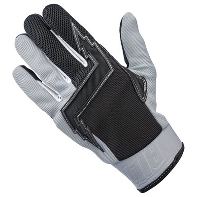 The '80s were the Golden Age of American motocross, when advances in gear design and material technology moved even faster than the legends who wore the stuff. That era and those riders were the inspiration for these Biltwell Baja gloves.
- Goat leather palm and thumb reinforcement for added toughness in these high friction areas.
- Synthetic suede palm and thumb construction for a snug, comfortable fit.
- Stretch polyester construction on ring and pinkie fingers for maximum flexibility.
- Three-ply woven mesh back panel for ventilation for comfort.
- Conductive stitching in fingers and thumb lets you operate smart screens.
- Molded two-ply neoprene wrist wrap with adjustable Velcro closure.
- Lycra expansion panels in finger joints for added dexterity.
- Rugged single- and double-needle polyester stitching throughout.
- Thermoplastic rubber lightning bolt knuckle protector.
- Hidden 5mm thick neoprene knuckle guard.
- Goat leather fingertips for extra durability.
- CE certified for recreational highway and off-road riding.