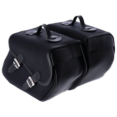 Longride Heritage saddlebags only without mounting brackets. 
Contains two small quick release waxed cotton saddlebags that are finished with ranger leather straps. 
Internal reinforcement plates help maintain its shape. 
The bags will not look bulky but are still large enough to hold the extra gear you need for a day trip. 
Designed to be used with model specific or universal 'Click & Lock' Longride saddlebag brackets. 
The low profile carrying handle is perfect for off-bike use. 
The Click & lock system makes it easy to remove the bag from your bike and carry your gear with you or into house, motel or tent. Manufactured from waxed cotton material with genuine Ranger Leather. 
Approx. dimensions: 38cm x 30cm x 17cm. 
Approx. capacity 23 liters per pair. 
Sold in pairs. 
Note: Universal 986406/986407 or a model specific saddlebag bracket is required for on-bike mounting and sold separately. 
Note: Some models will require turn signals relocated to the rear of the fenders struts.
