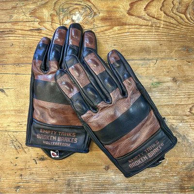 If you're looking for a pair of gloves that can handle any road, look no further than the Holy Freedom Dalton gloves. These gloves are made of 100% cowhide leather and has a full check print on the back for a stylish touch. They also have CE approved mould Elastopan Impact material on the knuckles and fingers to protect your hands from impacts. The index finger is touch-sensitive, so you can use your phone or GPS without taking off your gloves. The wrist has a Velcro flap regulator and a Lycra flap closure for a snug and comfortable fit. The Holy Freedom Dalton gloves are the perfect choice for riders who value quality, comfort and design. Get yours today and enjoy the freedom of the road!