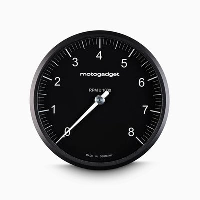 Black with Black Bezel. 
On this Chronoclassic 'Tacho Face' the large classic needle indicates RPM. Speed & all other functions are shown digital in red LED's. 
When switched off only the black face is visible, for a perfect classic look. The digital display, an in-house development by Motogadget, consists of a matrix of 512 tiny, super-bright red LEDs that shines through the dial when activated. 
The digital display has two lines. The top line shows the gear and speed/RPM and the bottom line shows the display values, which can be changed at the touch of a button. The illuminated pointer, perfectly illuminated backlight and an automatic brightness adjustment of the matrix LEDs for optimum readability in direct sunlight all the way to in the dark. 
Note: For non-fuel injected motorcycles a Motoscope Breakout Box is required to run the indicator lights. Available as 930311 H-D J1850 and 936577 Breakout Box A / 936578 Breakout Box B for universal applications. 
- Dimensions: 80mm diameter x just 22mm deep
- 11 indicator lights: Immobilizer / alarm (Plug & Ride only), Reserve, Oil temperature / water temperature, engine control / MIL / ABS / ASR (Plug & Ride only), oil pressure, turn signal left, turn signal right, high beam, neutral, universal warning light
- Compatible with CAN-bus vehicles 
- White illuminated pointer / needle 
- Shift light adjustable 0-20.000 RPM 
Digital display: 
- Gear indicator 
- Speed 999 [km/h/mph] 
- Trip A 999.9 [km/mi] 
- Trip B 999.9 [km/mi] 
- Odometer 999999 [km/mi] 
- Oil temperature 0-200 [°C / °F] 
- Water temperature 0-200 [°C/°F] 
- Air temperature -20 - 100 [°C/°F] 
- Oil pressure 0 - 10.0 [bar/psi] 
- Operating hours counter 9999 [h] 
- Travel time [hour/minutes/seconds] 
- Clock
- Time 0-100 km/h - 0 to 99.99 s 
- Acceleration 0 - 2.00 [G] 
- Average speed 999 [km/h/mph] 
- Maximum speed 999 [km/h/mph] 
- Maximum positive acceleration 0 - 2.00 [G] 
- Maximum negative acceleration 0 - 2.00 [G] 
- Maximum RPM digital 20.000 RPM 
- On-board voltage 9V - 18V 
- Fuel gauge 0% - 100% 
Adjustable warning messages: 
- Oil temperature 
- Water temperature 
- On-board voltage 
- Air temperature 
- Oil pressure 
- Tank capacity 
- Service interval 
- Speed warning (gear shift flash) 
Chromeclassic 2 includes: 
- Instrument with 75 cm connection cable & plug connection 
- Cable fuse 
- Speedometer sensor with 150 cm connection cable & two magnets 
- Mini push button 
- Stainless steel mounting screws 
- QR code for mounting and operating instruction 
