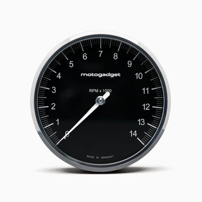 Black with Polished Bezel. 
On this Chronoclassic 'Tacho Face' the large classic needle indicates RPM. Speed & all other functions are shown digital in red LED's. 
When switched off only the black face is visible, for a perfect classic look. The digital display, an in-house development by Motogadget, consists of a matrix of 512 tiny, super-bright red LEDs that shines through the dial when activated. 
The digital display has two lines. The top line shows the gear and speed/RPM and the bottom line shows the display values, which can be changed at the touch of a button. The illuminated pointer, perfectly illuminated backlight and an automatic brightness adjustment of the matrix LEDs for optimum readability in direct sunlight all the way to in the dark. 
Note: For non-fuel injected motorcycles a Motoscope Breakout Box is required to run the indicator lights. Available as 930311 H-D J1850 and 936577 Breakout Box A / 936578 Breakout Box B for universal applications. 
- Dimensions: 80mm diameter x just 22mm deep
- 11 indicator lights: Immobilizer / alarm (Plug & Ride only), Reserve, Oil temperature / water temperature, engine control / MIL / ABS / ASR (Plug & Ride only), oil pressure, turn signal left, turn signal right, high beam, neutral, universal warning light
- Compatible with CAN-bus vehicles 
- White illuminated pointer / needle 
- Shift light adjustable 0-20.000 RPM 
Digital display: 
- Gear indicator 
- Speed 999 [km/h/mph] 
- Trip A 999.9 [km/mi] 
- Trip B 999.9 [km/mi] 
- Odometer 999999 [km/mi] 
- Oil temperature 0-200 [°C / °F] 
- Water temperature 0-200 [°C/°F] 
- Air temperature -20 - 100 [°C/°F] 
- Oil pressure 0 - 10.0 [bar/psi] 
- Operating hours counter 9999 [h] 
- Travel time [hour/minutes/seconds] 
- Clock
- Time 0-100 km/h - 0 to 99.99 s 
- Acceleration 0 - 2.00 [G] 
- Average speed 999 [km/h/mph] 
- Maximum speed 999 [km/h/mph] 
- Maximum positive acceleration 0 - 2.00 [G] 
- Maximum negative acceleration 0 - 2.00 [G] 
- Maximum RPM digital 20.000 RPM 
- On-board voltage 9V - 18V 
- Fuel gauge 0% - 100% 
Adjustable warning messages: 
- Oil temperature 
- Water temperature 
- On-board voltage 
- Air temperature 
- Oil pressure 
- Tank capacity 
- Service interval 
- Speed warning (gear shift flash) 
Chromeclassic 2 includes: 
- Instrument with 75 cm connection cable & plug connection 
- Cable fuse 
- Speedometer sensor with 150 cm connection cable & two magnets 
- Mini push button 
- Stainless steel mounting screws 
- QR code for mounting and operating instruction 
