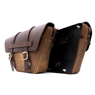 Handcrafted from 100% heavy duty leather and built to last. Originally designed as a panel bag set that replaces the right & left side side panels on Royal Enfield 650 Twin motorcycles, but let nobody tell you you can't install it anywhere else. Small but large enough for some tools and other on-hand applications. Opens with an easy push button system and a unique zip puller also allows the bag to be locked.
Dimensions: 30cm upper width x 15cm lower width x 20cm high x 6.5cm deep.
Capacity: 2.8 liter per bag